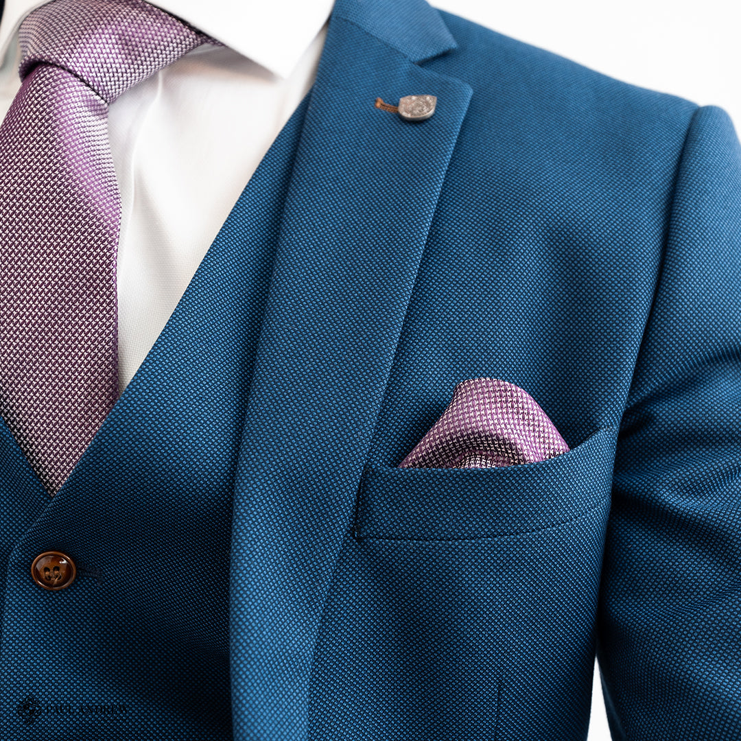 Groom wearing a bespoke men’s wedding suit by Paul Andrew